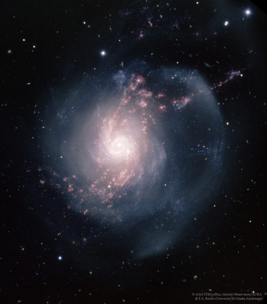 Composite optical image of Arp 217 taken with the 8.1 metre Gemini North Telescope at Mauna Kea, Hawaii. It was created using broadband filters, B-band (blue), R-band (green), and a narrow-band filter focused on the emission of ionised hydrogen (Hα filter, red).