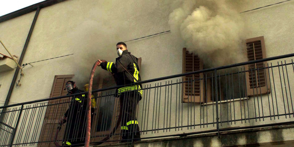 Firefighters responding to a smoke-filled building.