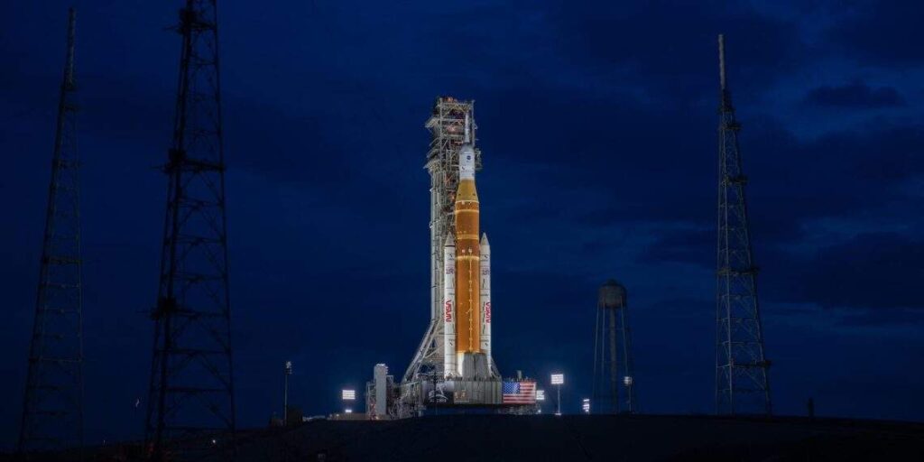 NASA Space Launch System SLS rocket illuminated at night on the launch pad at Kennedy Space Center, ready for the Artemis II crewed Moon mission in April 2026