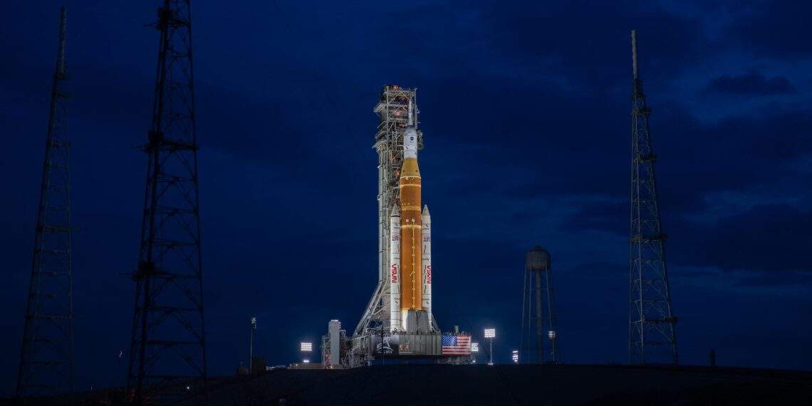 NASA Space Launch System SLS rocket illuminated at night on the launch pad at Kennedy Space Center, ready for the Artemis II crewed Moon mission in April 2026