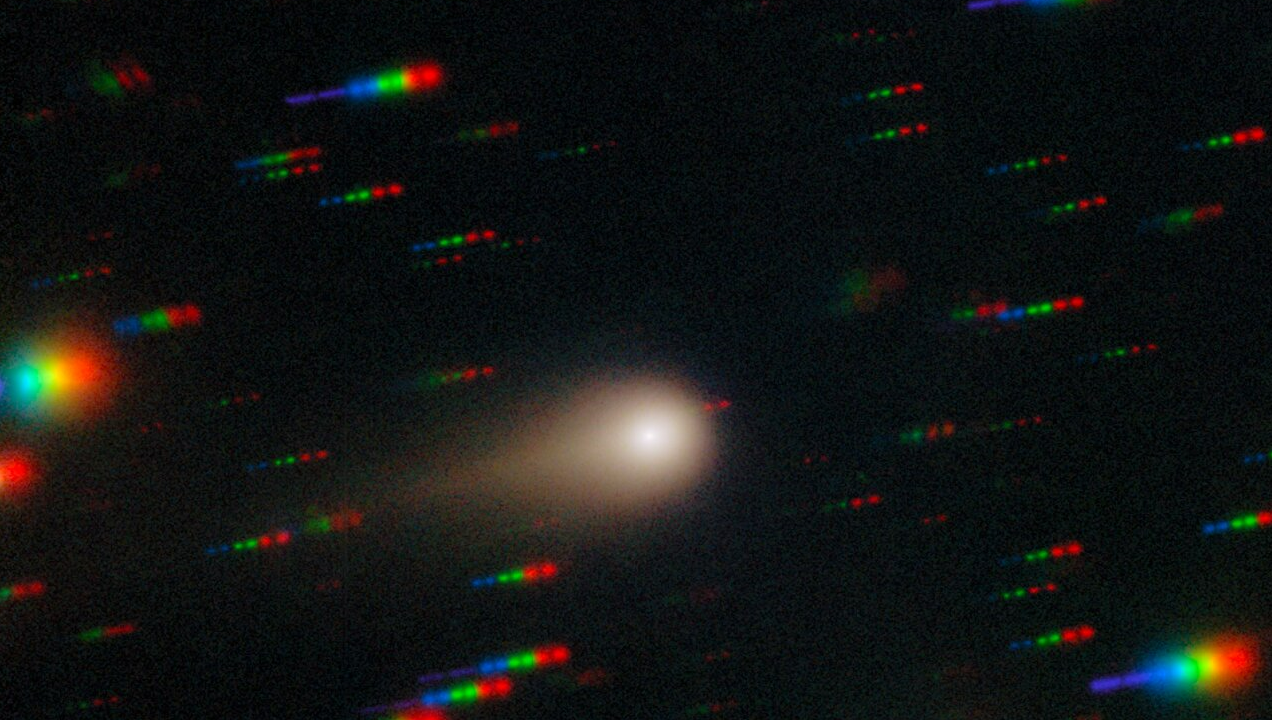 Bright comet with colorful star trails