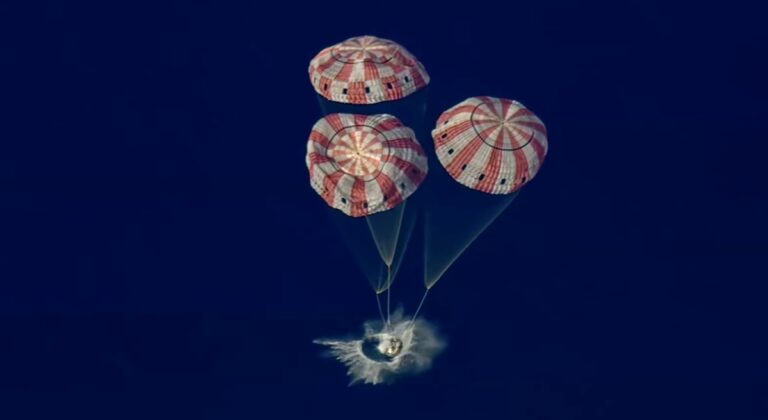 NASA Orion capsule from Artemis II splashes into the Pacific Ocean under four red-and-white parachutes after returning from the Moon, April 10, 2026.