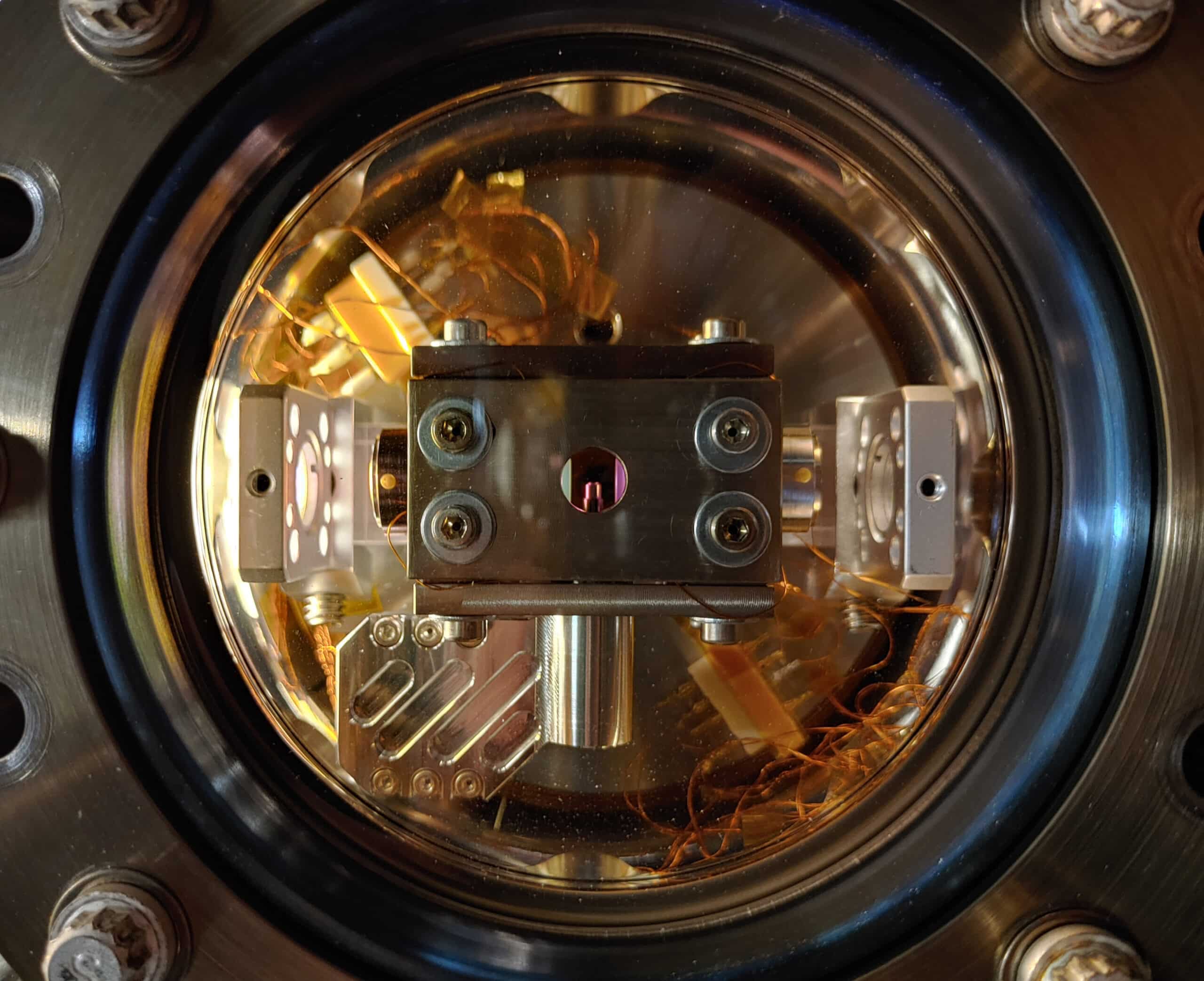 The vacuum chamber with the experimental setup to levitate a particle inside of a cavity. The cavity consists of two mirrors coated to be extremely reflective for infrared light. The cylindrical part in the center holds a lens at its tip to focus the infrared laser down to a point at which the particle is trapped. Credit: Johannes Piotrowski