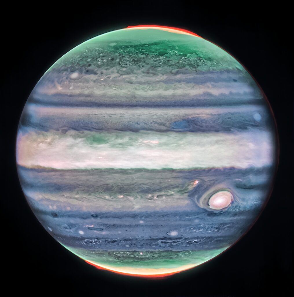 Infrared image of Jupiter from James Webb Space Telescope showing bright bands, white Great Red Spot, and vivid orange auroras at both poles. Credit: NASA, ESA, CSA, STScI.
