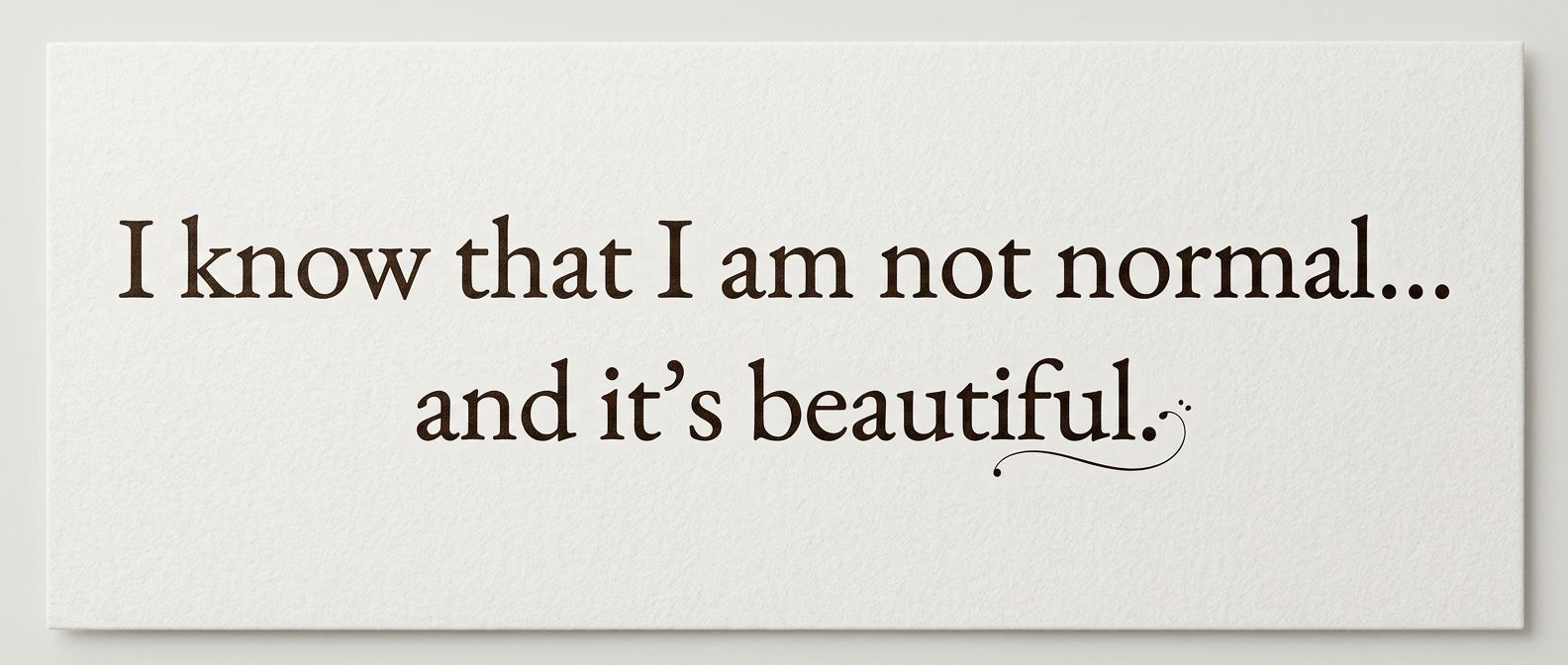 Alt Text (WordPress Alternative Text field): Elegant black serif quote "I know that I am not normal… and it's beautiful" printed on textured white paper.