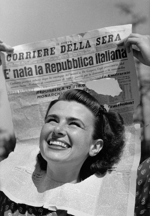 Smiling young Italian woman holding the Corriere della Sera front page "È nata la Repubblica italiana" announcing Italy's Republic Day birth on June 2, 1946