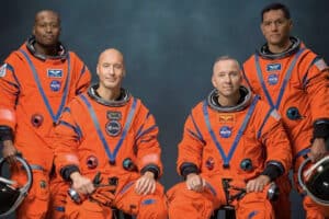 Artemis III crew in orange Orion suits: Andre Douglas, Luca Parmitano, Randy Bresnik and Frank Rubio pose for NASA portrait.