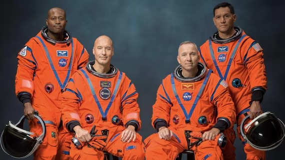 Artemis III crew in orange Orion suits: Andre Douglas, Luca Parmitano, Randy Bresnik and Frank Rubio pose for NASA portrait.