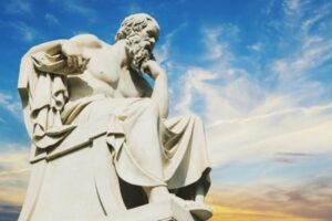 Marble statue of philosopher Socrates seated in thought at the Academy of Athens, symbolizing the Socratic method and Western philosophy