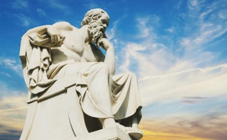 Marble statue of philosopher Socrates seated in thought at the Academy of Athens, symbolizing the Socratic method and Western philosophy